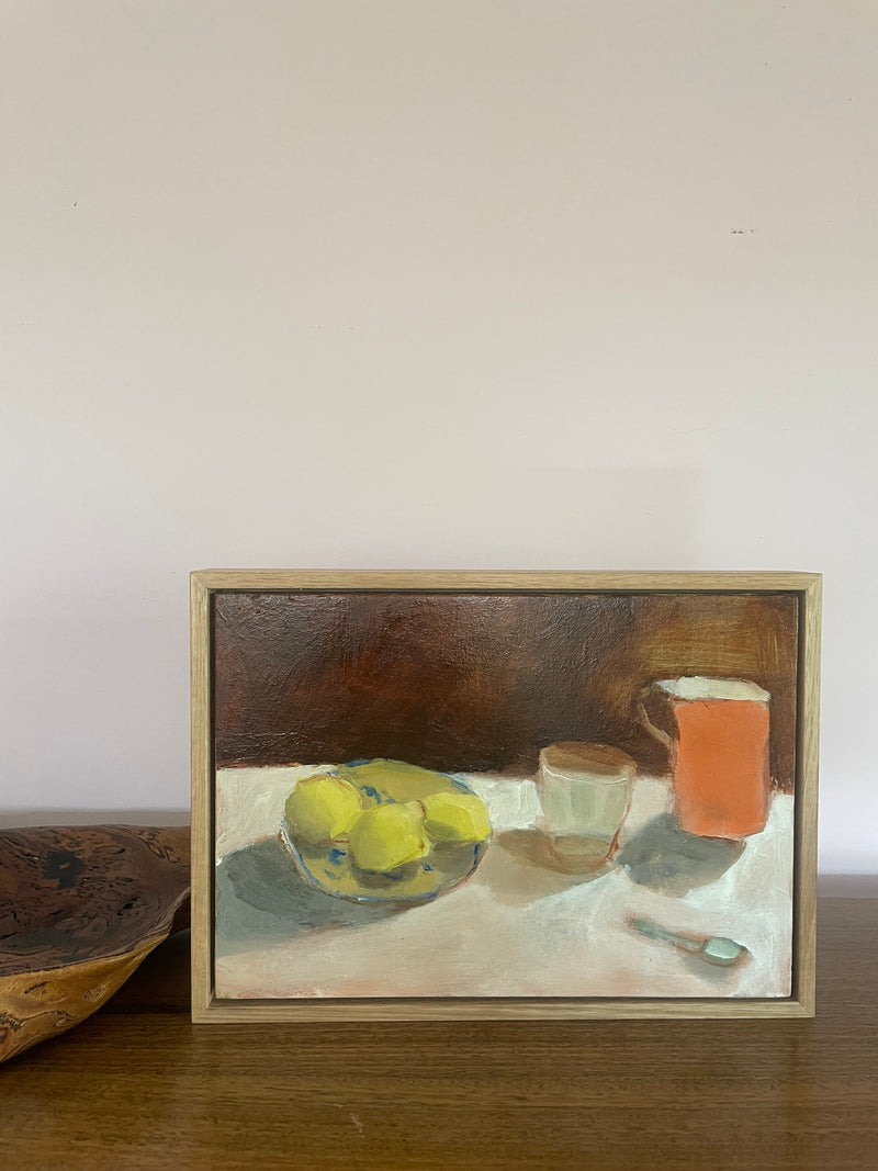 Lemons On A Plate With Glass And Orange Jug